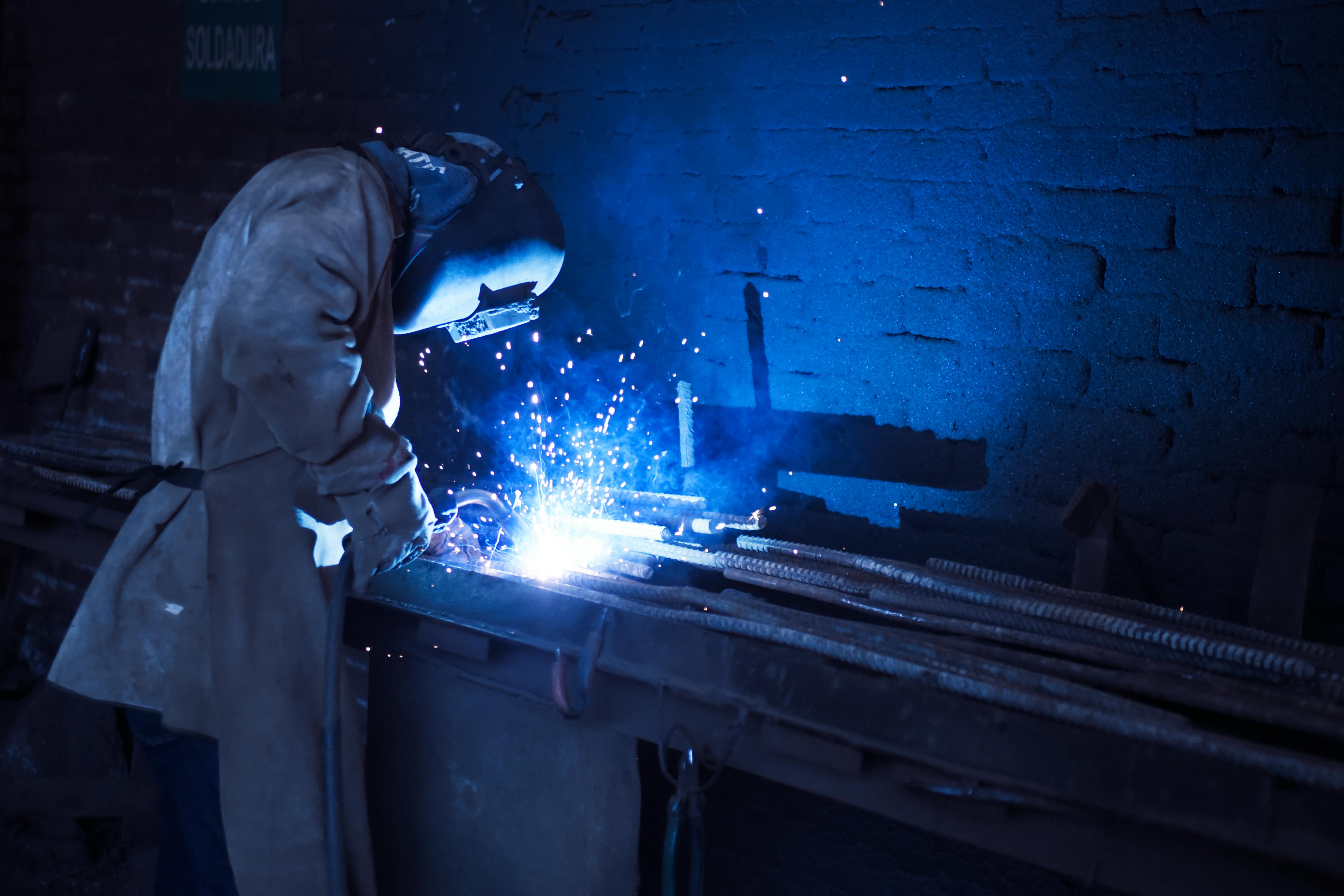 Miller MIG welder in use at a fabrication workshop